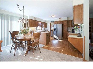 Open Kitchen features new wood laminate flooring