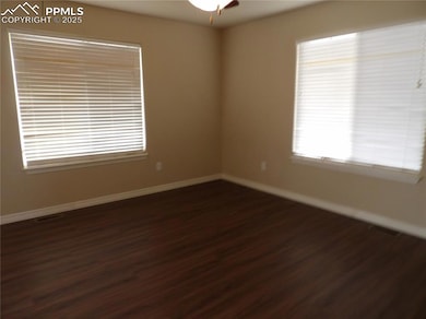 Unfurnished room with dark wood-type flooring