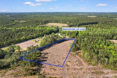 Birds eye view of property with a wooded view