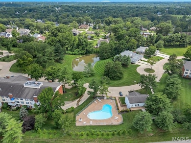 Aerial view of property's location featuring a nearby body of water and a pool