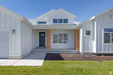 Doorway to property featuring board and batten siding, a garage, and roof with shingles
