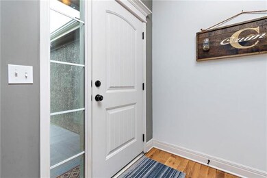 And we’re in...big and bright foyer with hardwood 