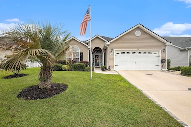 View of front of property with an attached garage, concrete driveway, and a front lawn