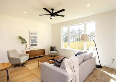 Living room featuring baseboards, light wood-type