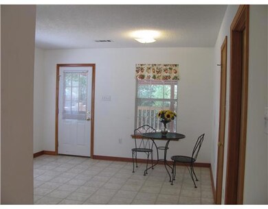 Kitchen. The kitchen has lots of windows.  The bac