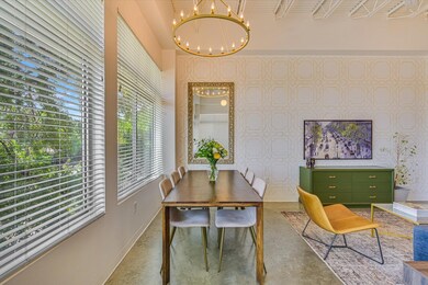 Dining room with finished concrete flooring, a ch