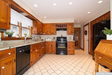 Spacious kitchen has new granite counter tops.