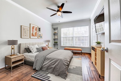 The owner’s retreat offers hardwood floors throughout, a large window allows the easy flow of natural light, built-in shelving is offered for convenience and a mounted TV is conveyed with the sale of the home.