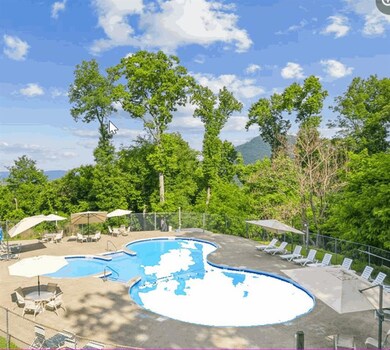 Pool featuring fence and a patio