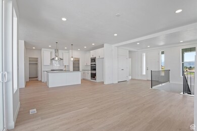 Unfurnished living room featuring light wood-style flooring and recessed lighting
