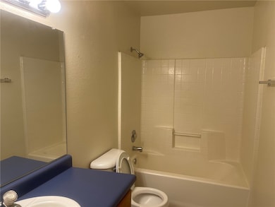 Bathroom with vanity, shower / washtub combination