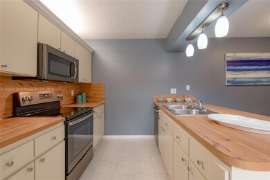 KITCHEN OFFERS PLENTY OF STORAGE COUNTER SPACE & DOUBLE SINKS