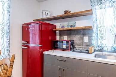 Kitchen with open shelves, freestanding refrigerat