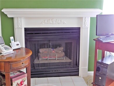 Gas fireplace with beautiful mantel.