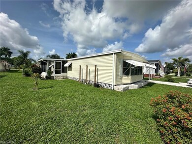 View of property exterior featuring a lawn