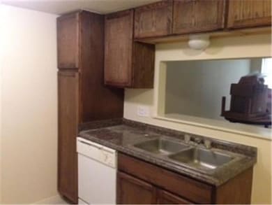 Kitchen featuring white dishwasher, a sink, and d