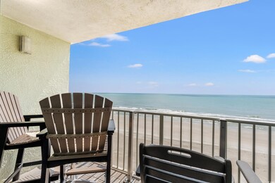 Balcony featuring a water view and a beach view
