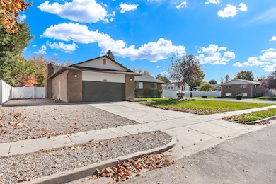 Ranch-style house with brick siding, driveway, an attached garage, and a residential view
