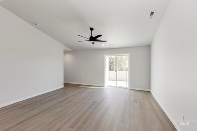 Unfurnished room with light wood-style floors, a ceiling fan, and vaulted ceiling