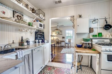 Kitchen featuring white appliances, ceiling fan, c
