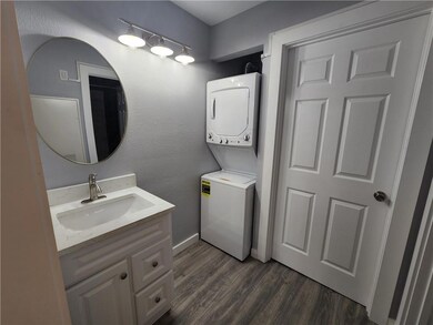 Bathroom featuring stacked washer / drying machin