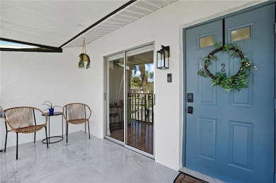 Charming front entry with covered patio, perfect for relaxing with morning coffee or evening conversation.