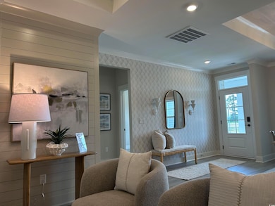 Living area featuring ornamental molding, wood finished floors, recessed lighting, and wallpapered walls