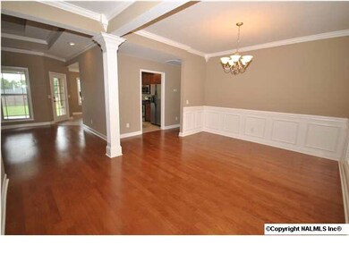 Dining room with columns, beautiful hardwood floors and fresh pain