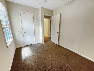 Unfurnished bedroom featuring carpet flooring and a ceiling fan