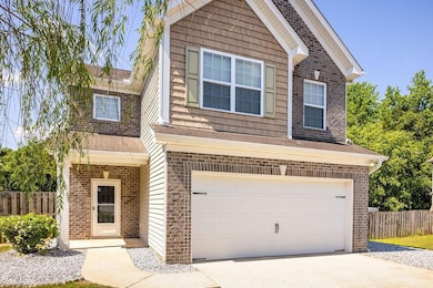 View of front of house with brick siding, an attac