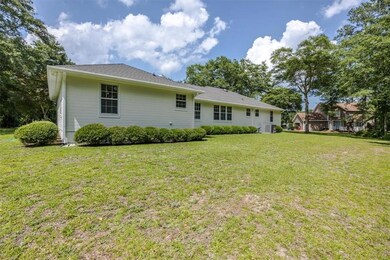 Rear view of house with a yard