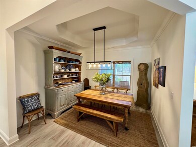 Dining room with light wood-style flooring, a tray