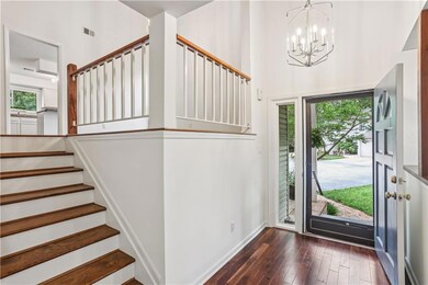 Two story foyer with stairs up to main level and down to lower level.