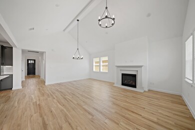 Impressive great room with fireplace and vaulted c