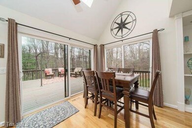 Hardwood floors in Dining area, skylights add natural light, new sliding glass door.
