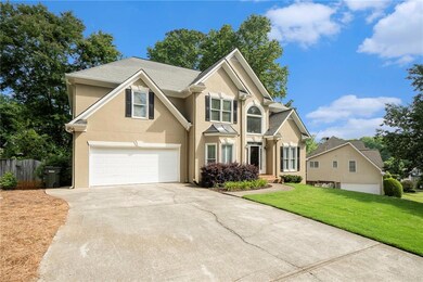 Traditional home with stucco siding, driveway, and