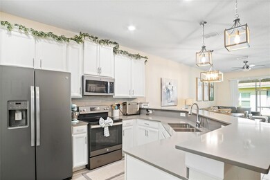 Quartz countertops and stainless steel appliances give a sleek and clean look to the kitchen.