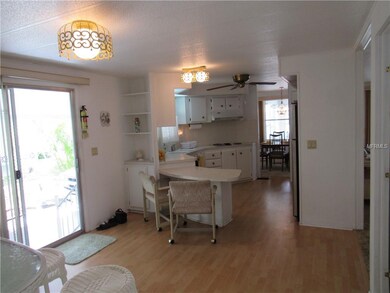 View of left entrance door and into the kitchen.