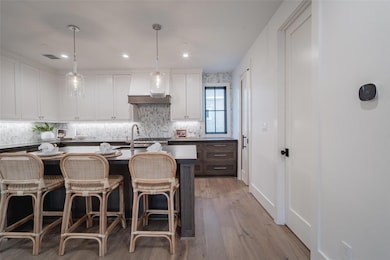 Kitchen featuring decorative light fixtures, an is