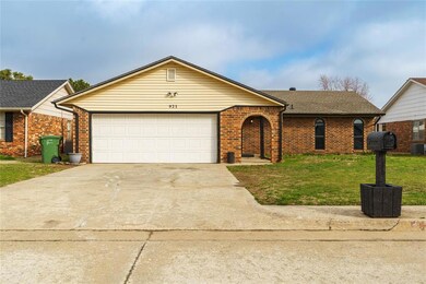 Ranch-style home with a front lawn, a garage, and central AC unit