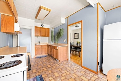 Kitchen featuring range, sink, light hardwood / wo