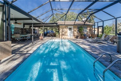 screen enclosed pool with view of pool house-offic