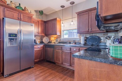 Nice kitchen with back splash  Refrigerator stays