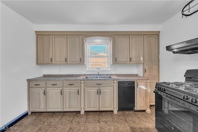 Kitchen featuring black appliances, range hood, light brown cabinets, and light countertops