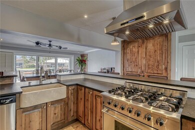 Kitchen with marble farmhouse sink, rustic wood ca