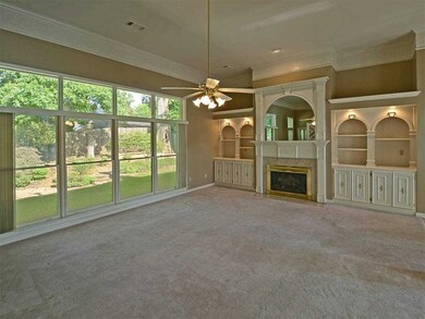 The greatroom features a fireplace and built-in di