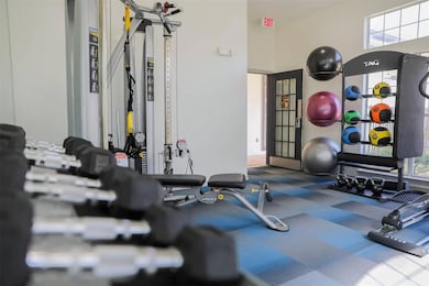 Gym featuring a healthy amount of sunlight and a h