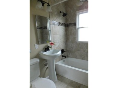 Dream bathroom down totally redone with pedestal sink, custom tile work and all new bronze fixtures,