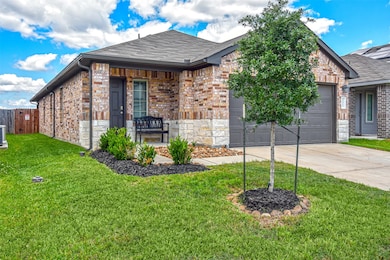 This is a modern, single-story brick home with a t
