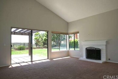 Living room with high vaulted ceiling, brick firep